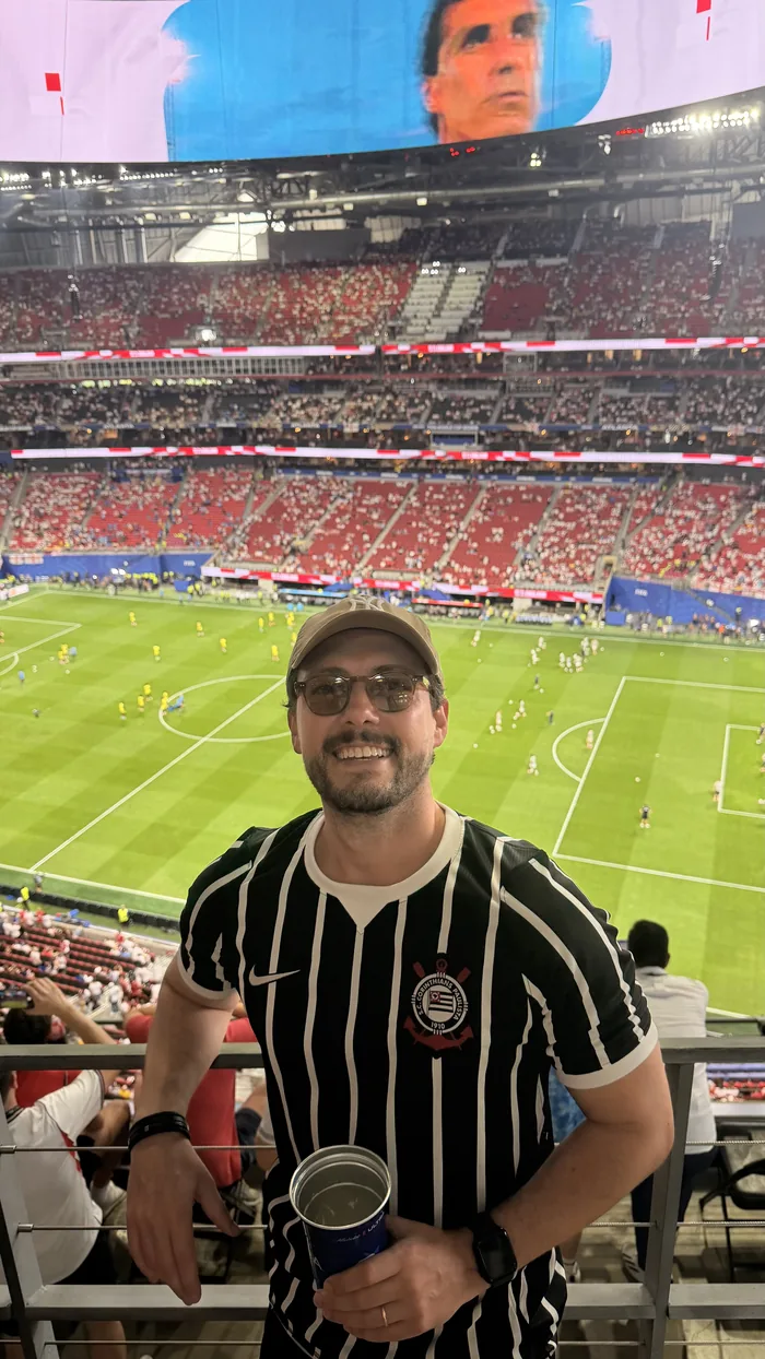 Augusto in a Corinthians shirt at a World Cup stadium