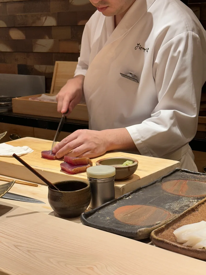A chef preparing a course during Augusto's omakase in Tokyo